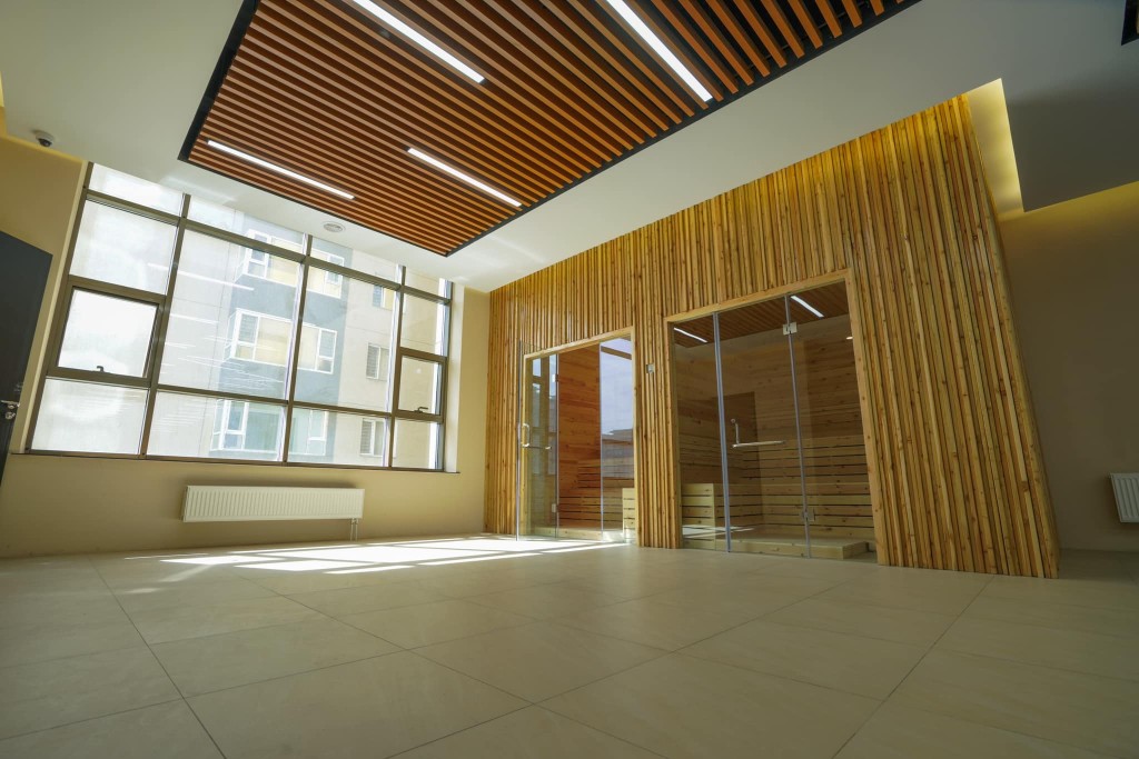 Modern sauna interior with wooden benches and ambient lighting